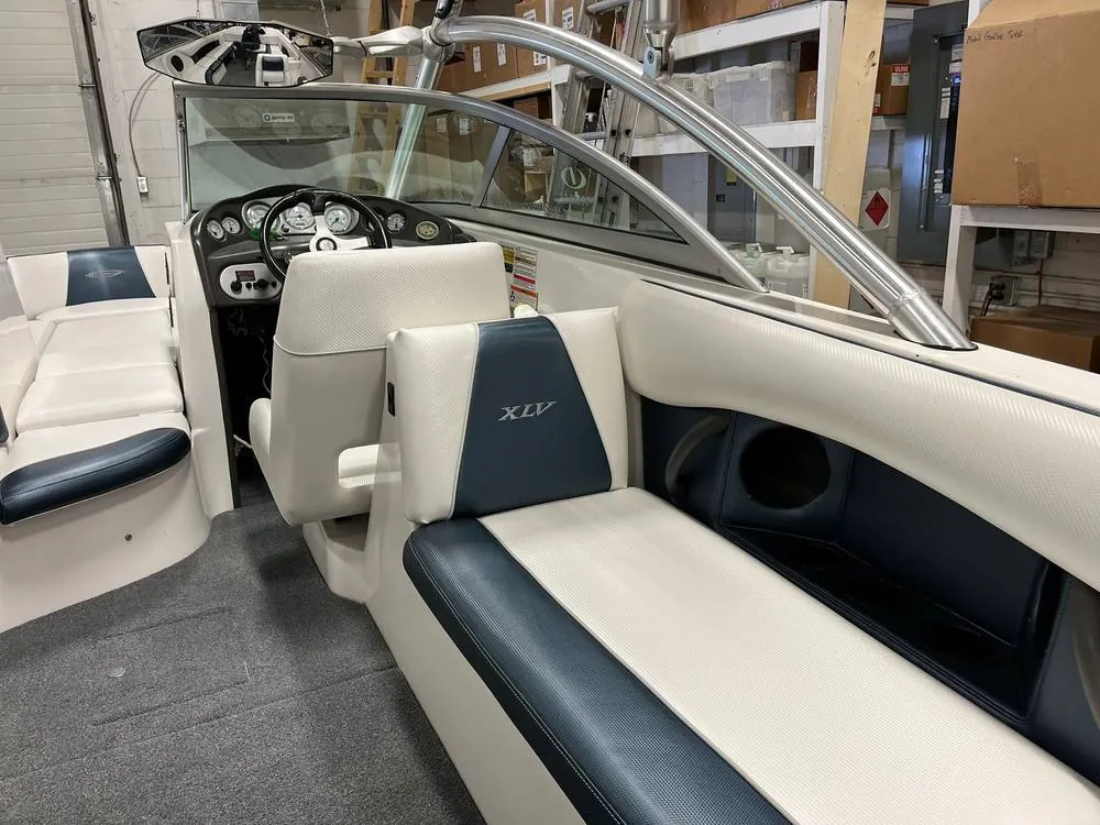 After: Boat cockpit seating recovered in white and blue-gray marine vinyl