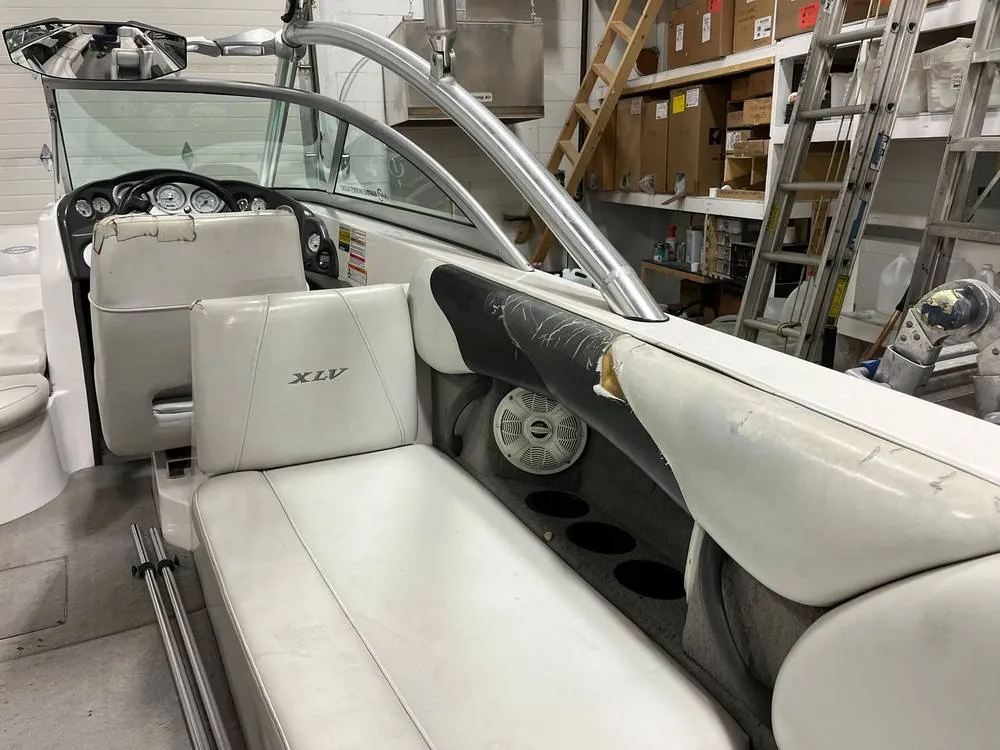 Before: Boat cockpit seating with torn, peeling gray and white vinyl