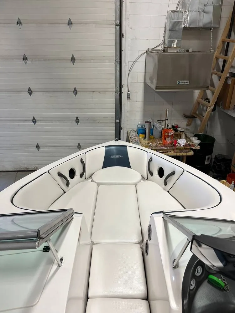 After: Moomba bow seating redone in white vinyl with a blue-gray panel