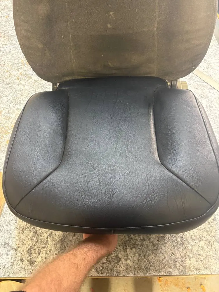 After: Seat cushion recovered in black vinyl